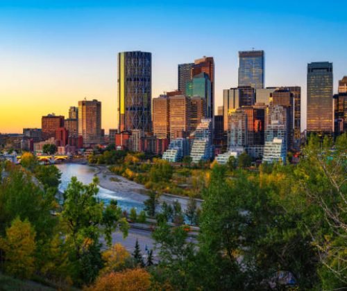Sunset above city skyline of Calgary with Bow River, Alberta, Canada.